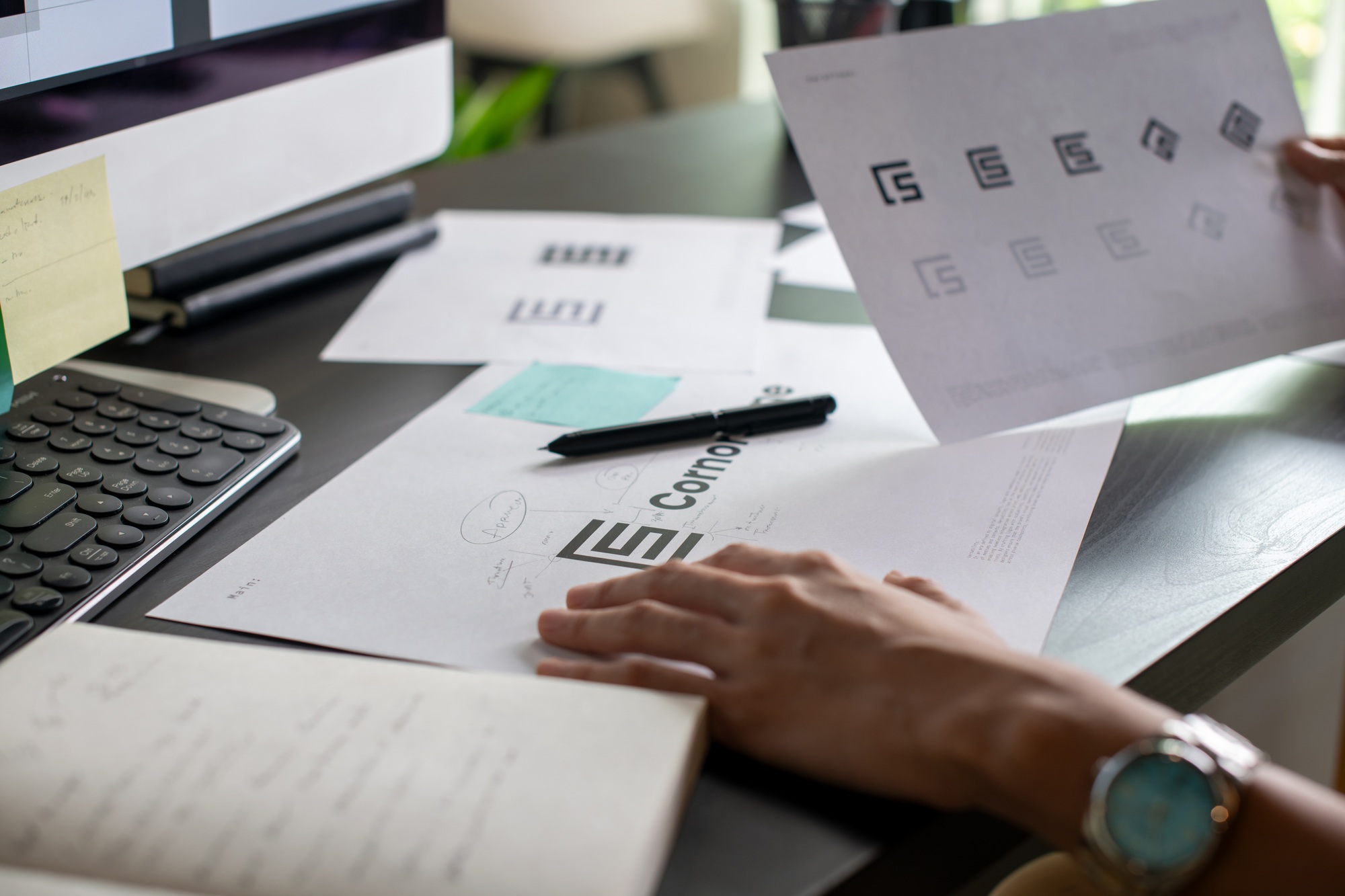 Graphic designer drawing sketches logo design.